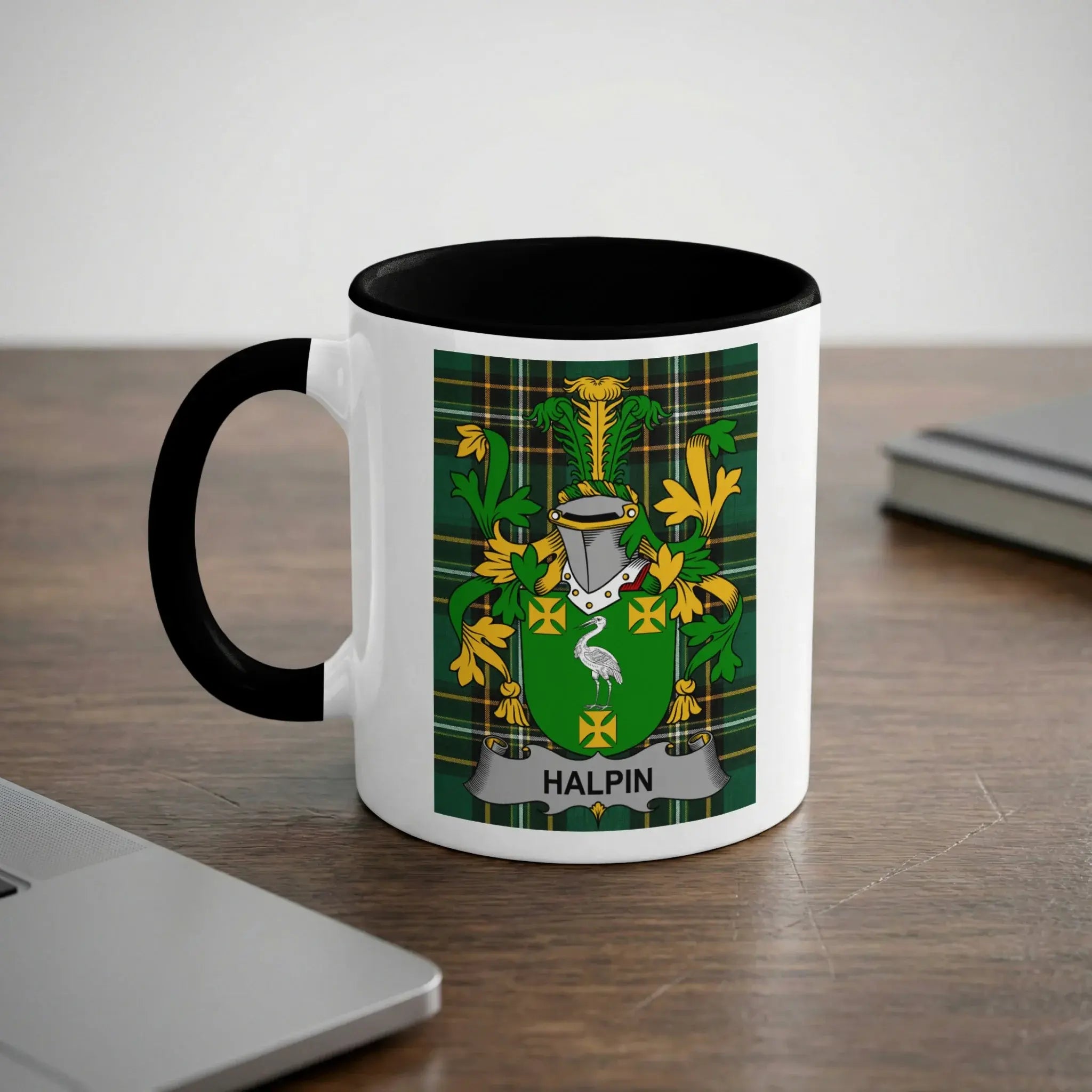 White mug with black rim featuring a green coat of arms with a crane and "HALPIN".