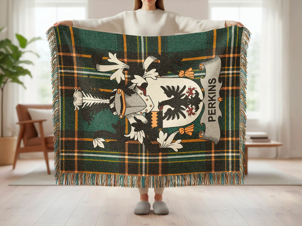 Green plaid blanket featuring a coat of arms with the name PERKINS.