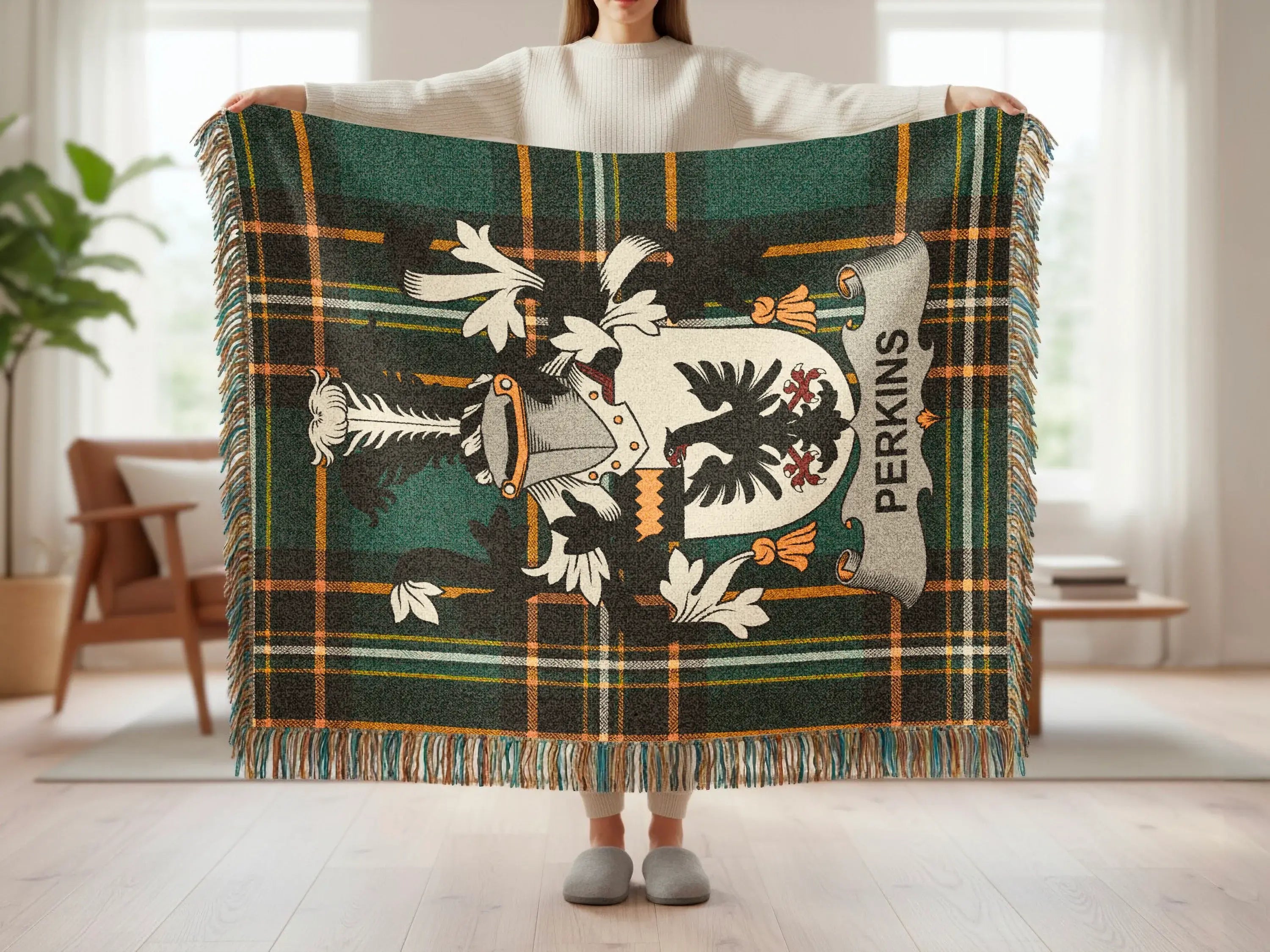 Green plaid blanket featuring a coat of arms with the name PERKINS.