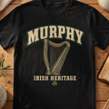 Murphy Irish harp T-shirt in Black, with cream surname lettering, a gold-toned harp, green shamrock and “Irish Heritage” text.