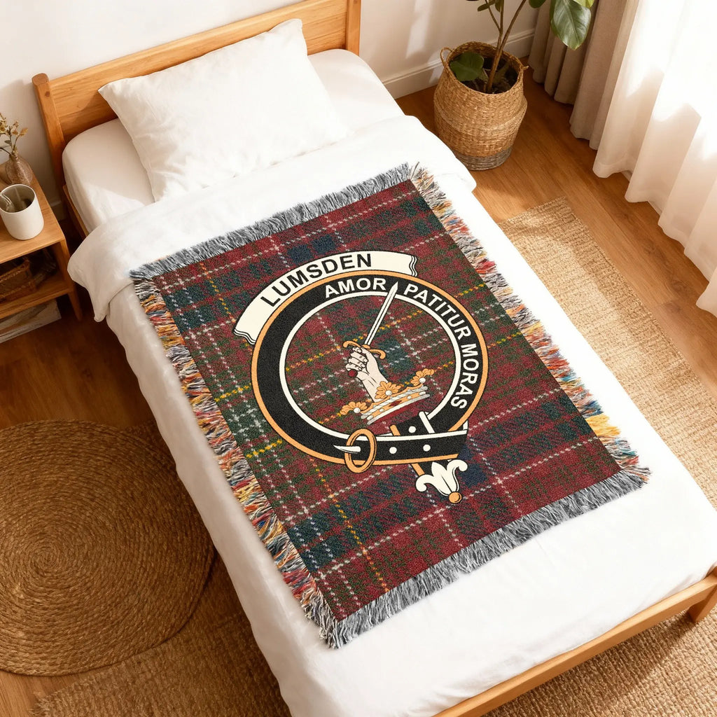 Clan Lumsden Amor Patitur Moras woven blanket — folded showing fringe detail and crest on red tartan