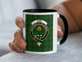 Don Scottish surname crest artwork on an 11 oz black accent mug with a tartan background