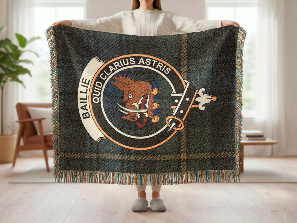 Person holding the Baillie woven blanket to show the full design, tartan background and fringe