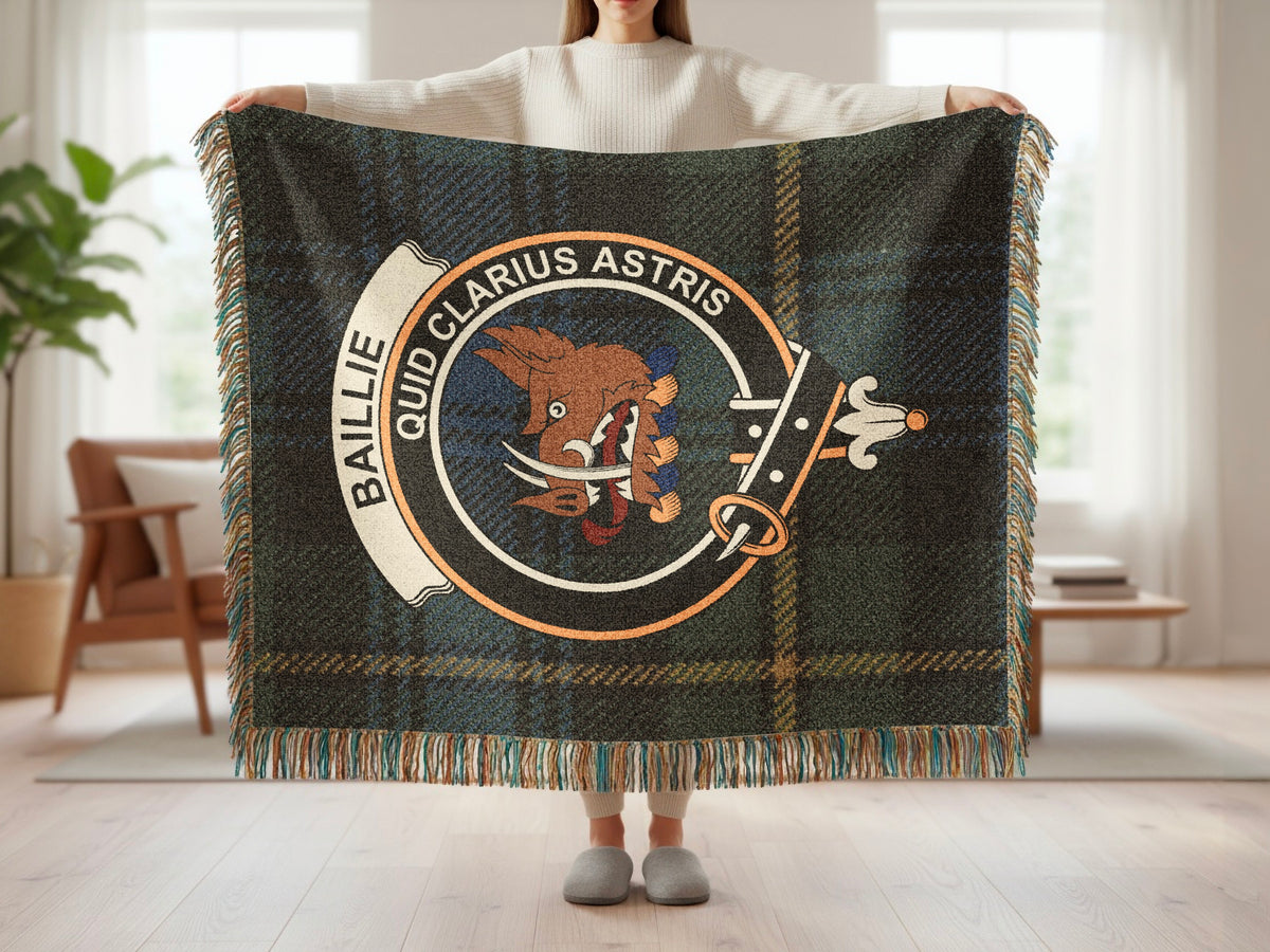 Person holding the Baillie woven blanket to show the full design, tartan background and fringe