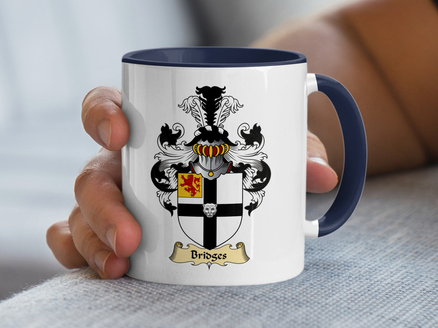 White mug with navy handle featuring Bridges coat of arms.