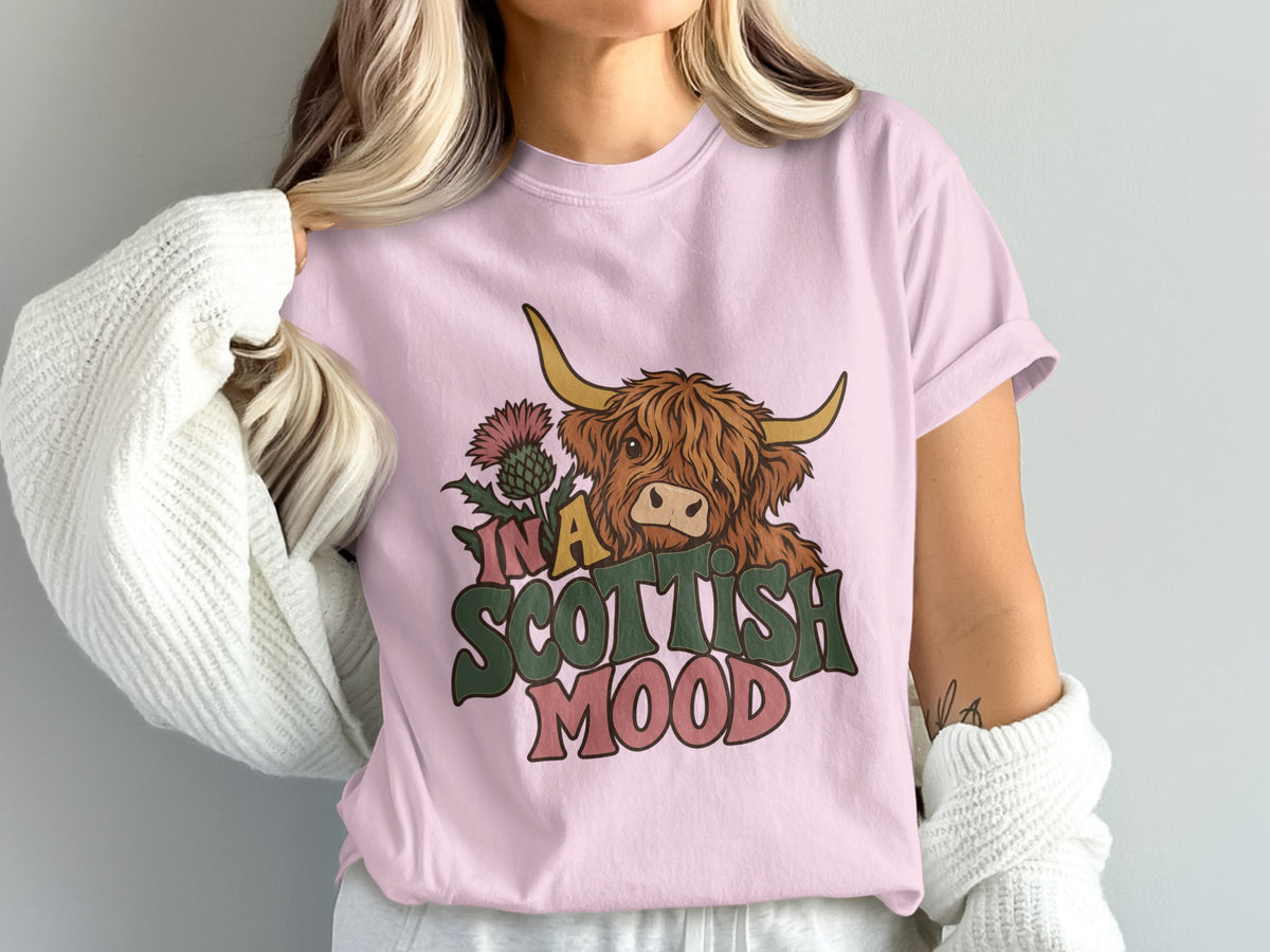 Model wearing the In a Scottish Mood Highland cow Comfort Colors T-shirt in Blossom