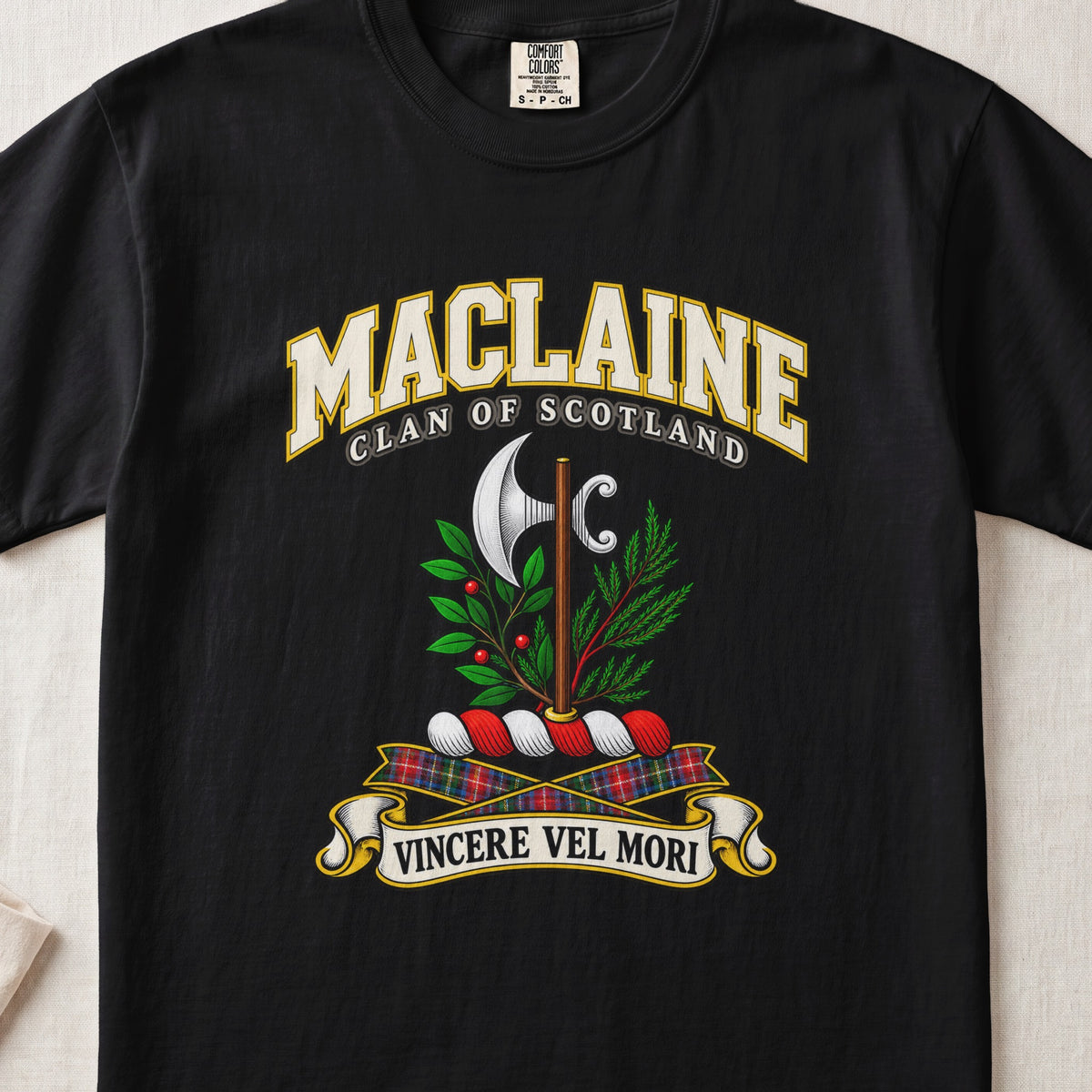 MacLaine Scottish clan T-shirt in Black, front view with a silver axe framed by green foliage and motto banner.