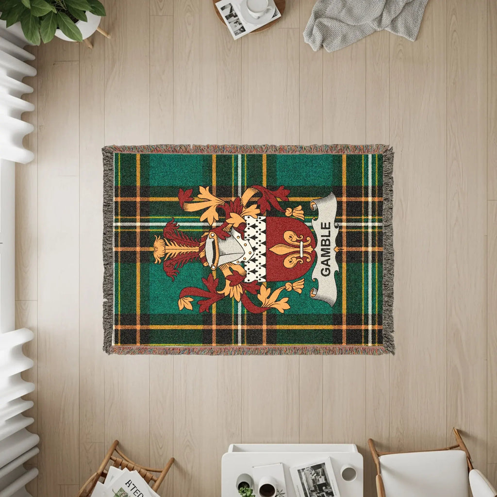 Gamble tartan blanket with coat of arms on a wooden floor.