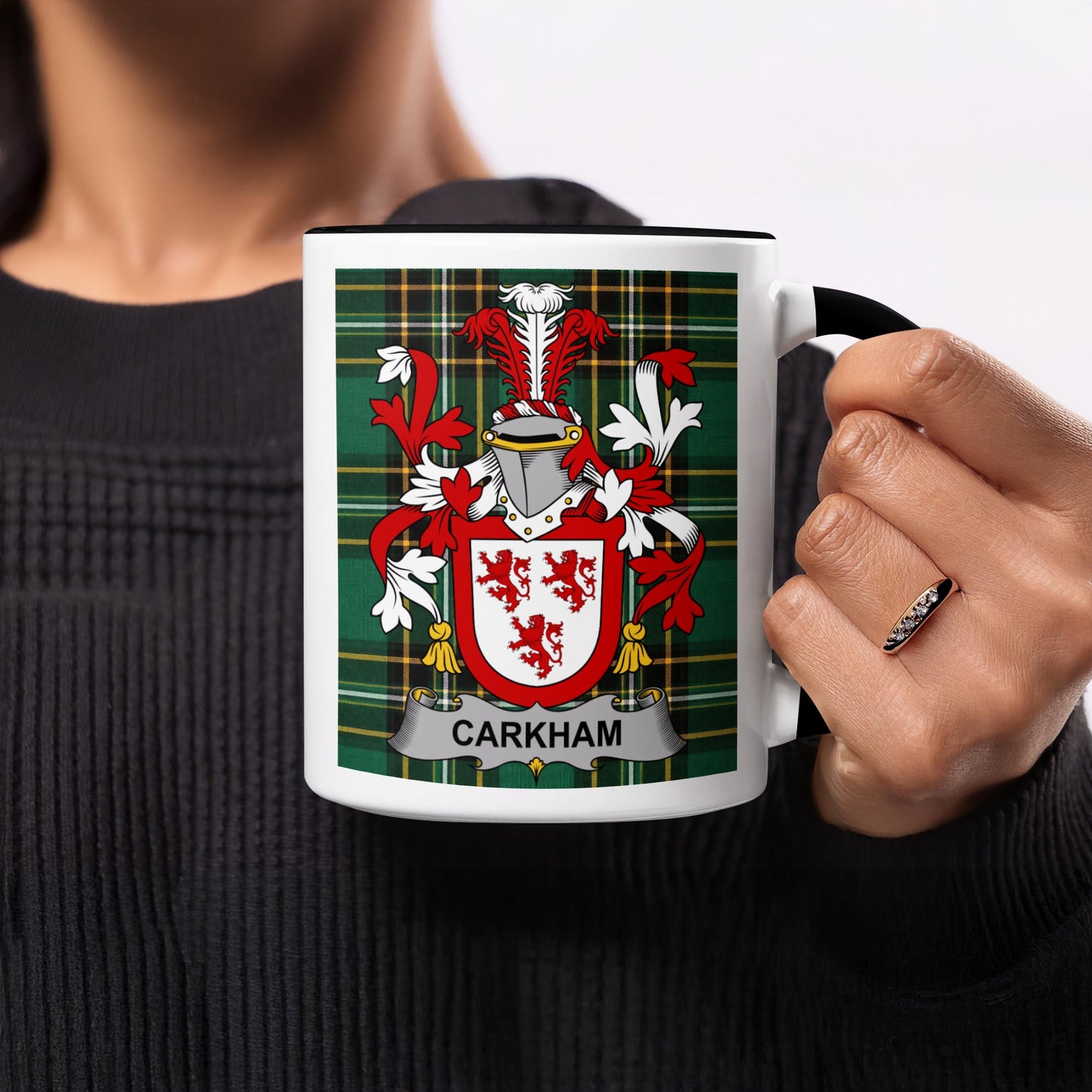 White mug with black handle featuring a tartan pattern and the "CARKHOM" coat of arms.