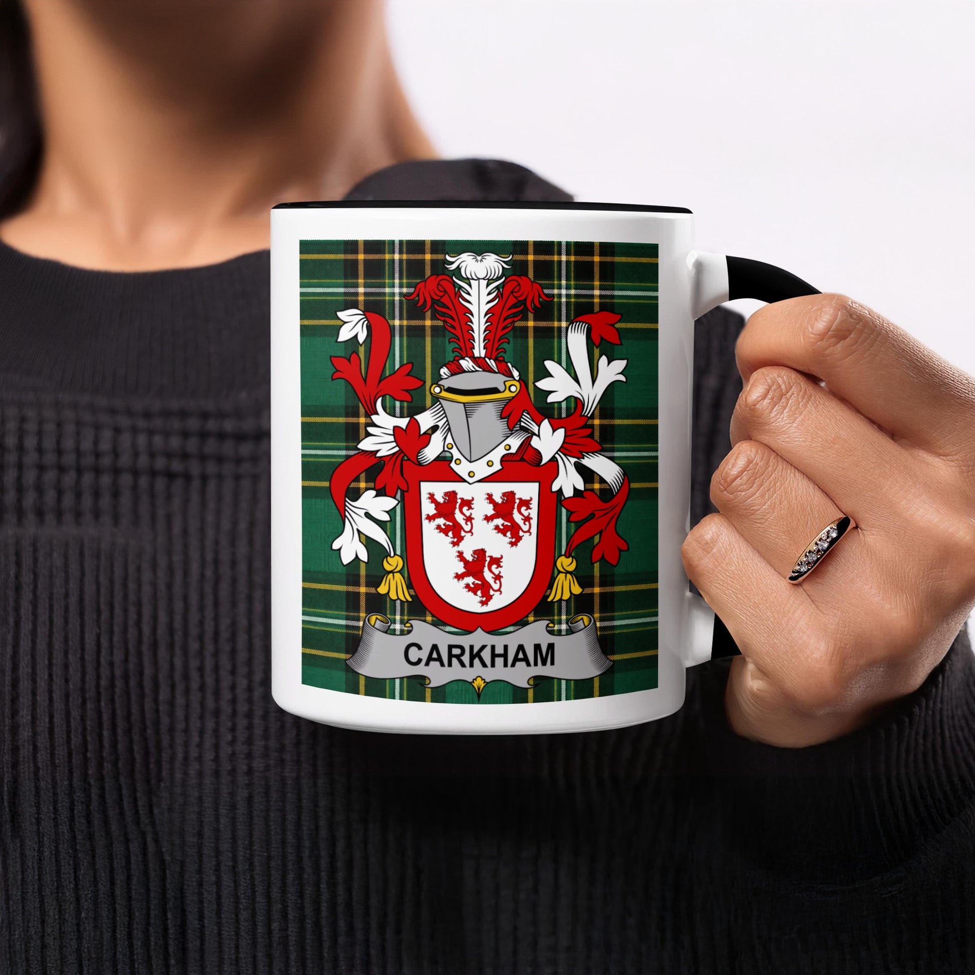 White mug with black handle featuring a tartan pattern and the "CARKHOM" coat of arms.