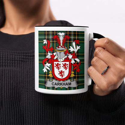 White mug with black handle featuring a tartan pattern and the "CARKHOM" coat of arms.