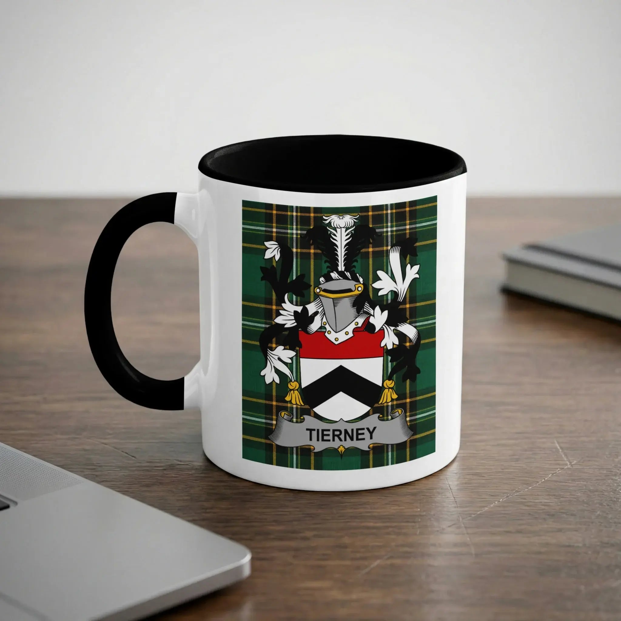 White mug with black rim featuring a green plaid crest with the name TIERNEY.