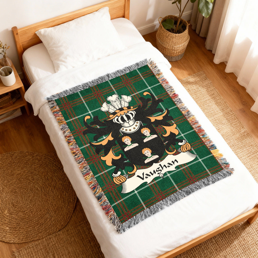 Green plaid throw blanket with a family crest featuring the name "Vaughan".