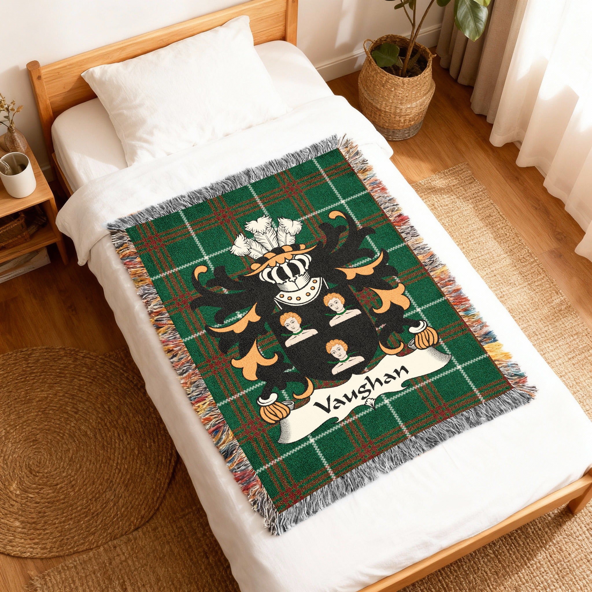 Green plaid throw blanket with a family crest featuring the name "Vaughan".