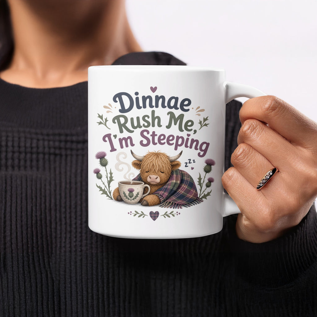 Highland cow wrapped in blanket holding mug with text "Dinnae Rush Me, I'm Sleeping".