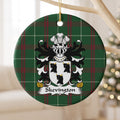 Skevington ceramic ornament with white shield with three black bull heads and gold horns on Welsh National Tartan, hanging beside a pale branch.