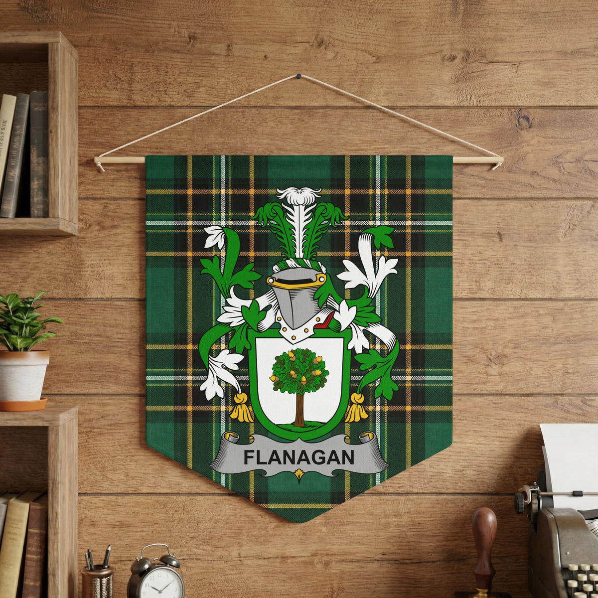 Flanagan family crest on green tartan pennant hanging on a wooden wall.