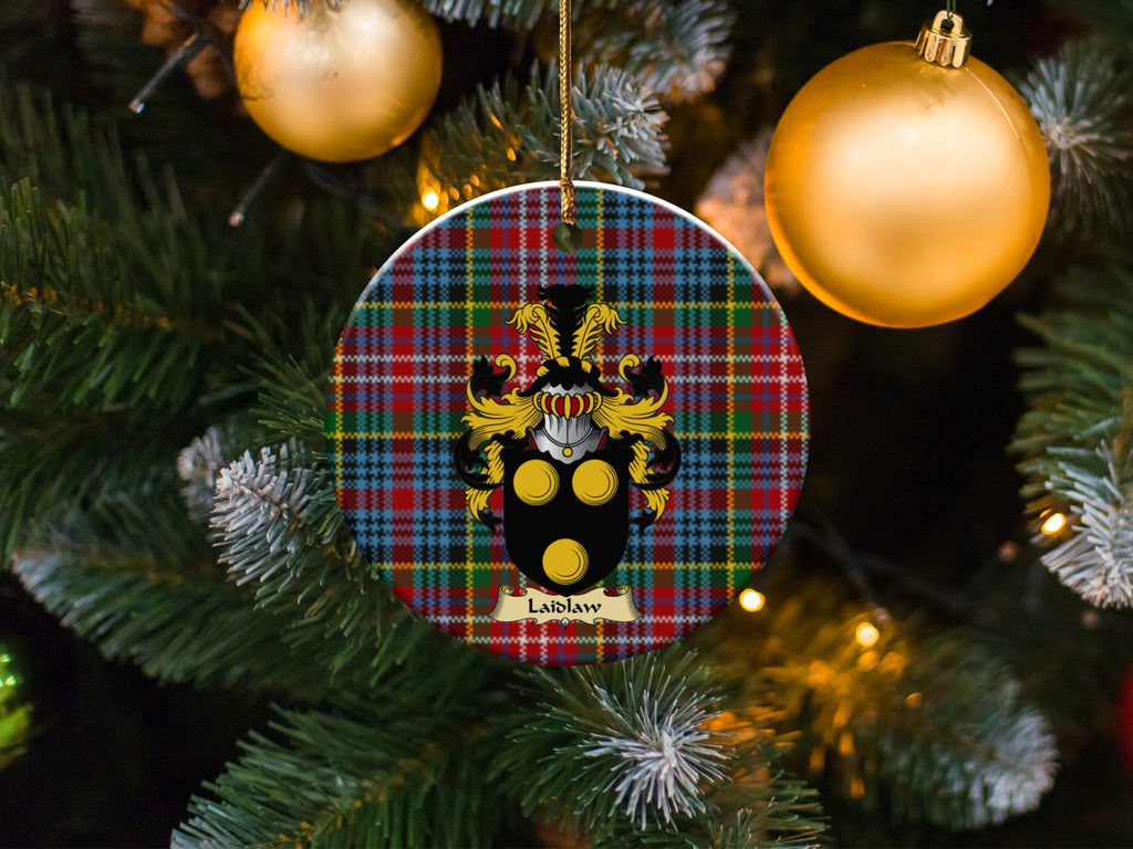 Laidlaw family emblem ceramic Christmas ornament with Caledonia tartan background in festive holiday décor