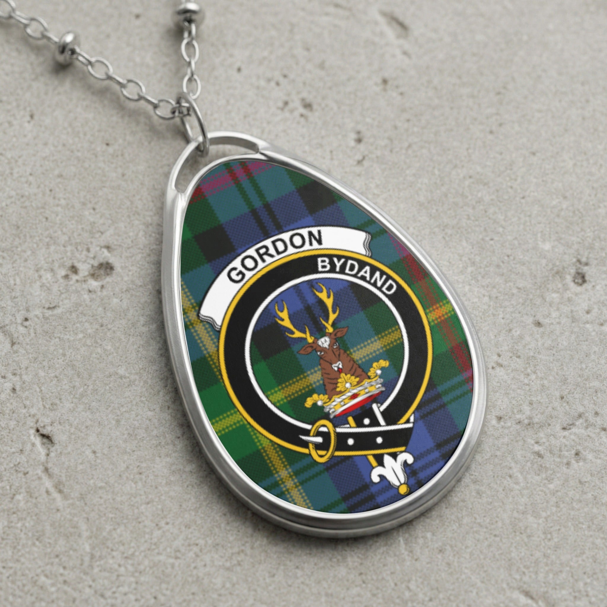 Gordon clan Scottish tartan necklace with clan crest and Bydand motto on tartan background
