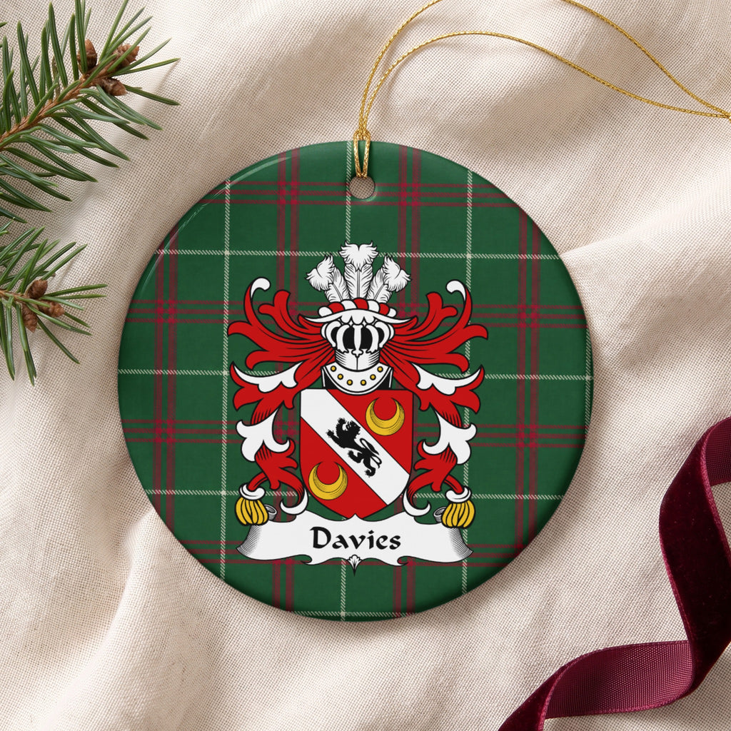 Davies Style 2 ornament on cream fabric with gold string, evergreen and burgundy ribbon; a black lion on a white diagonal band with two gold crescents on red.
