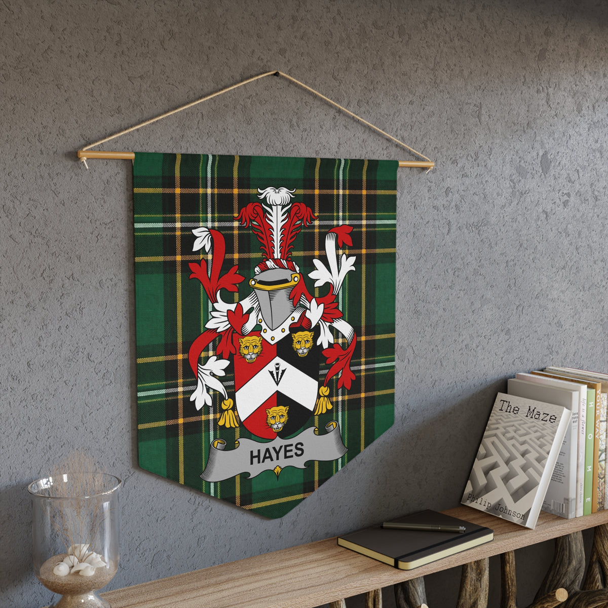 Hayes family crest on a green tartan pennant hanging on a wall.