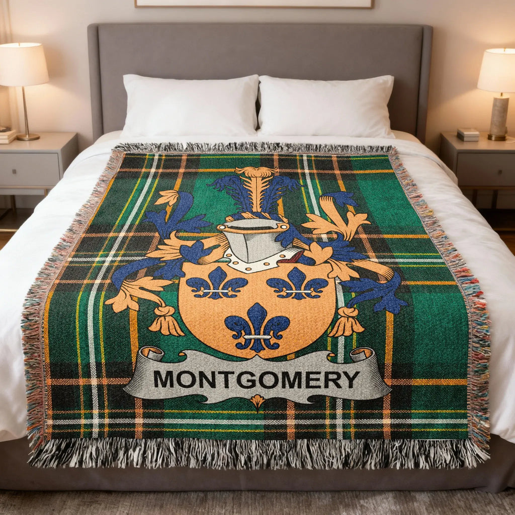 Montgomery family crest on green plaid woven throw blanket on a bed.