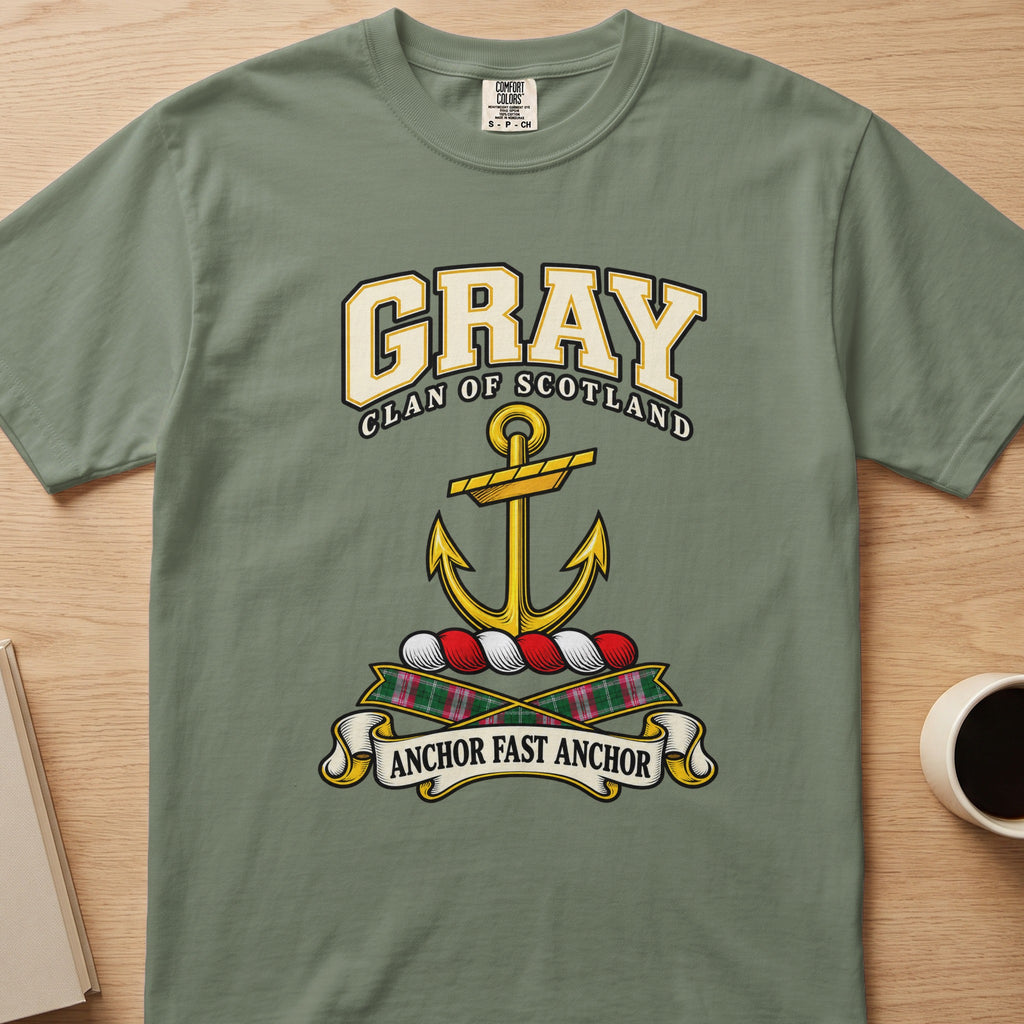 Gray clan crest with gold anchor on a sage green Comfort Colors T-shirt, front view