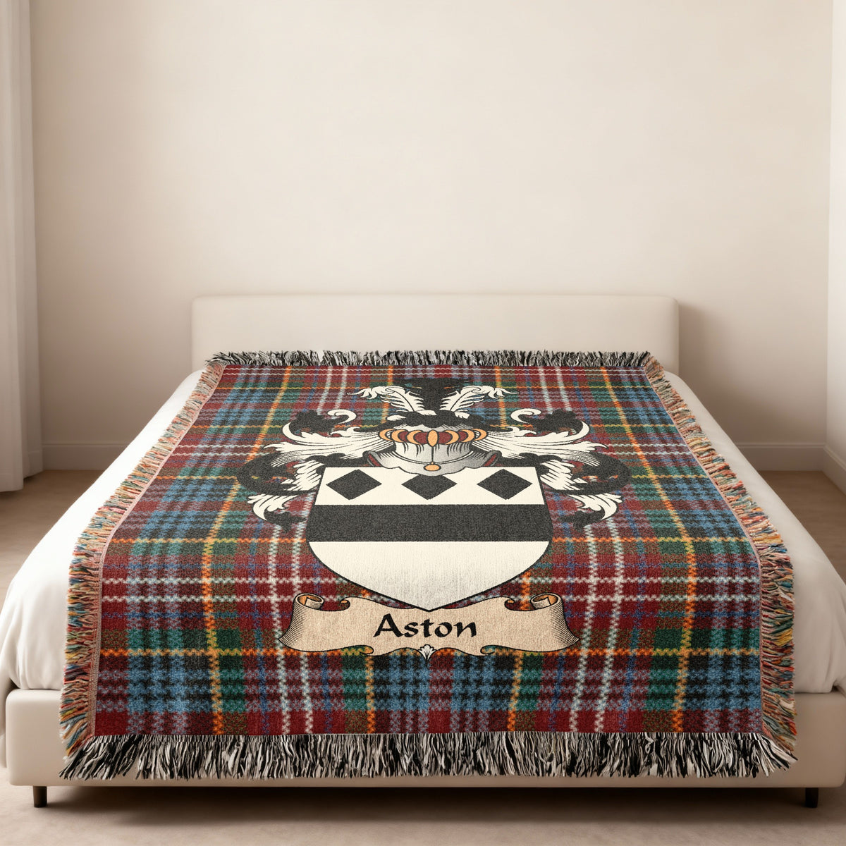 Aston family crest emblem on a Caledonia tartan woven blanket