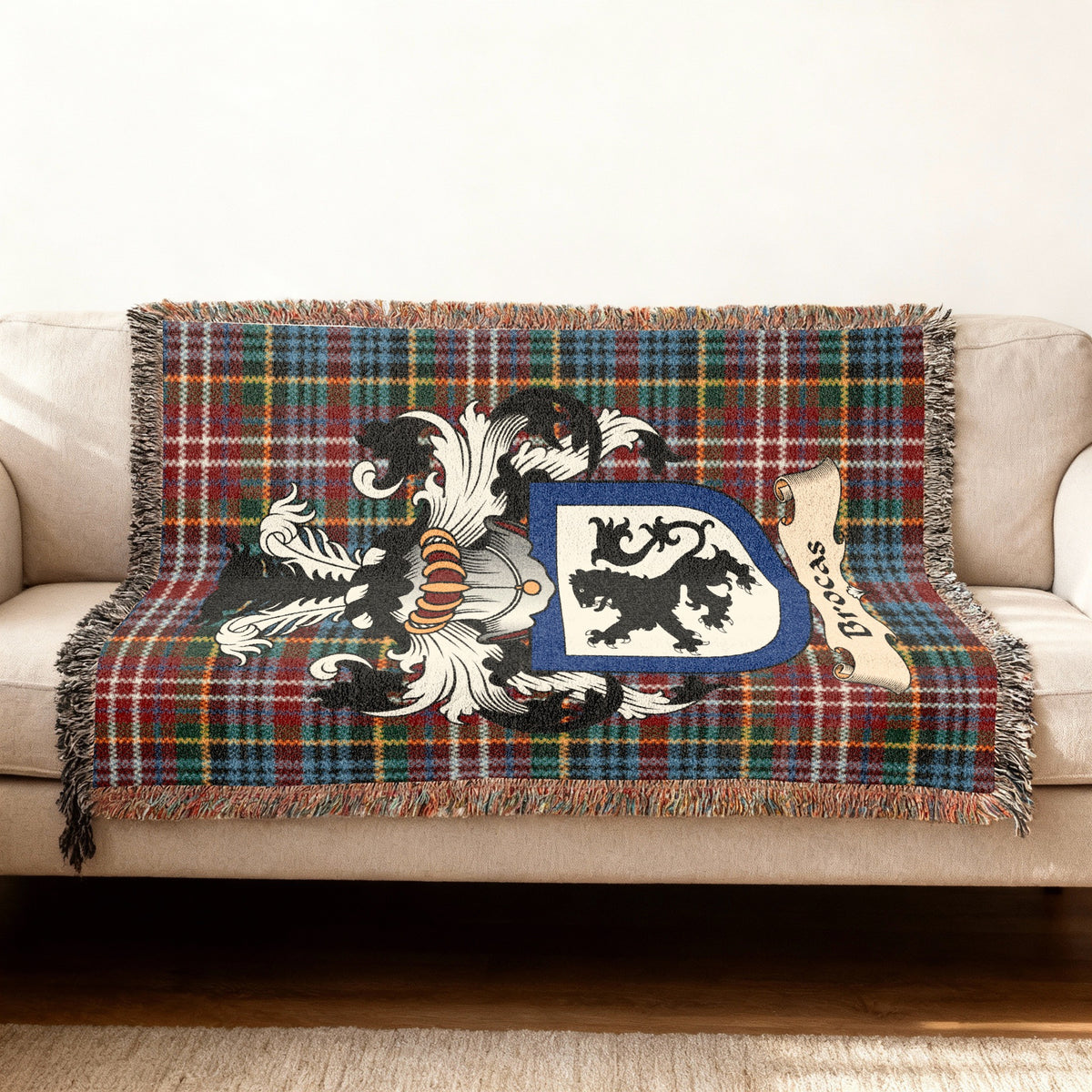 Features of the Brocas Scottish family shield woven blanket with Caledonia tartan background