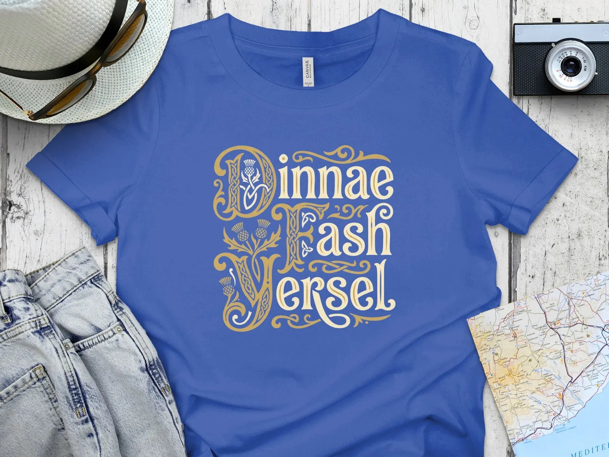 Blue t-shirt with gold Celtic knot lettering "Jinnae Fash Versel".