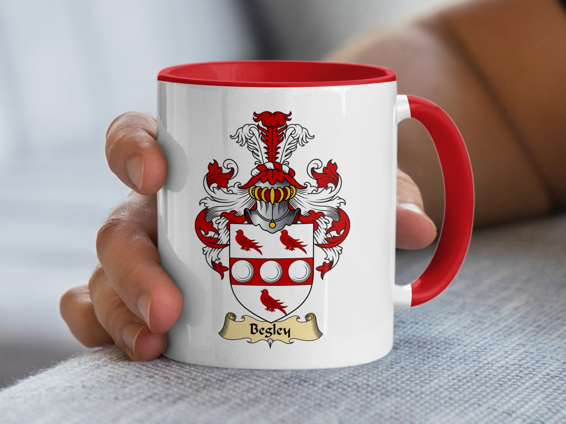 White mug with red handle, featuring a red and white crest with "Begley" banner.