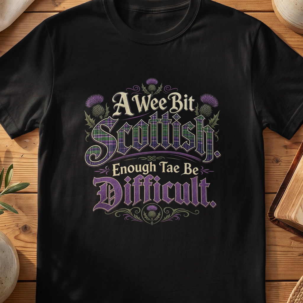 Black Gildan 64000 unisex T-shirt flatlay with A Wee Bit Scottish Enough Tae Be Difficult Scottish graphic design