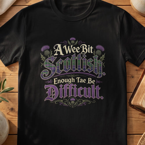 Black Gildan 64000 unisex T-shirt flatlay with A Wee Bit Scottish Enough Tae Be Difficult Scottish graphic design