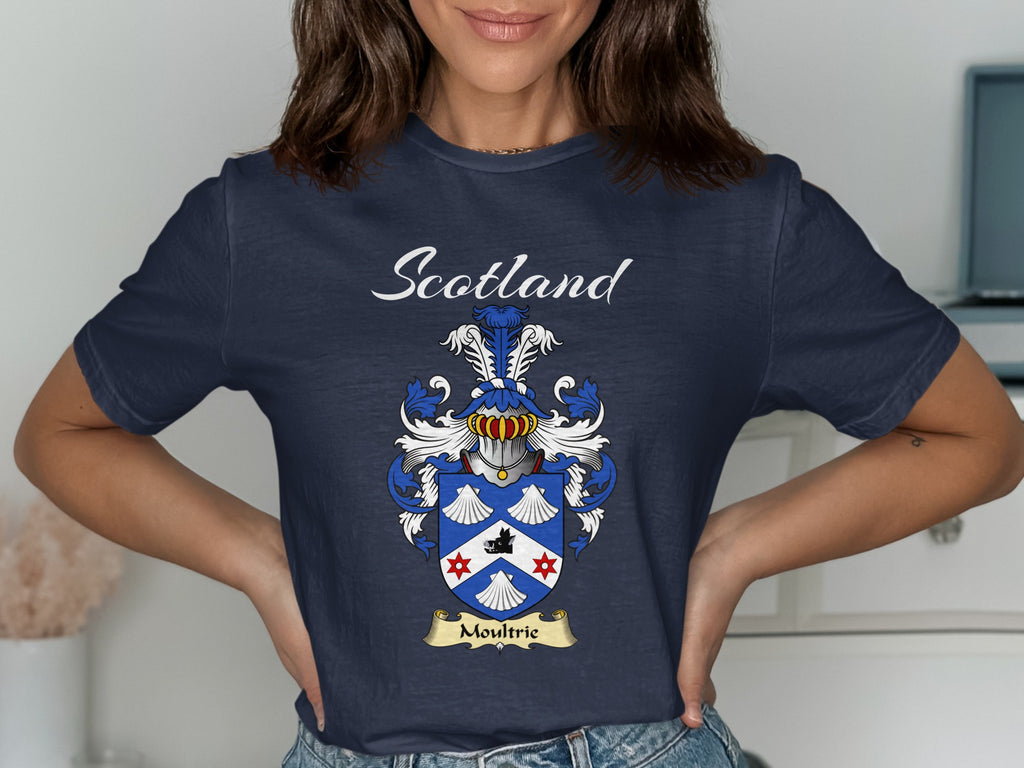 Model wearing a navy Moultrie T-shirt featuring shell motifs and a white chevron on blue