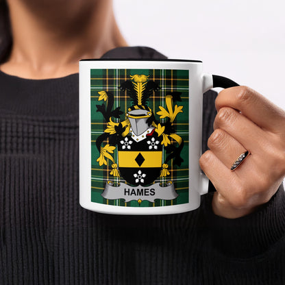 Mug with black handle featuring a green, yellow, and black plaid pattern and a coat of arms with the name "HAMES".