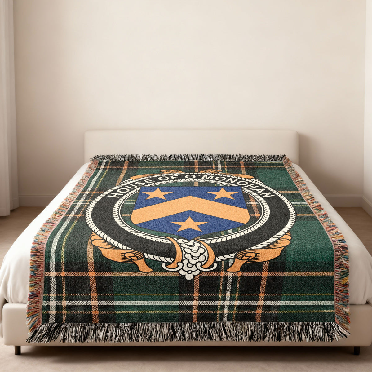 O'Monohan family crest emblem woven blanket displayed on a bed