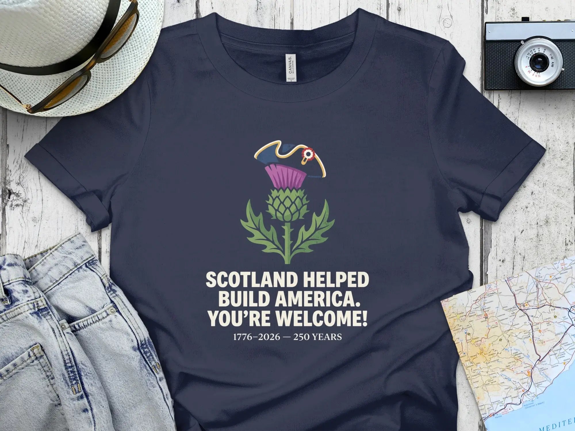 Navy t-shirt with Scotland helped build America text and thistle.