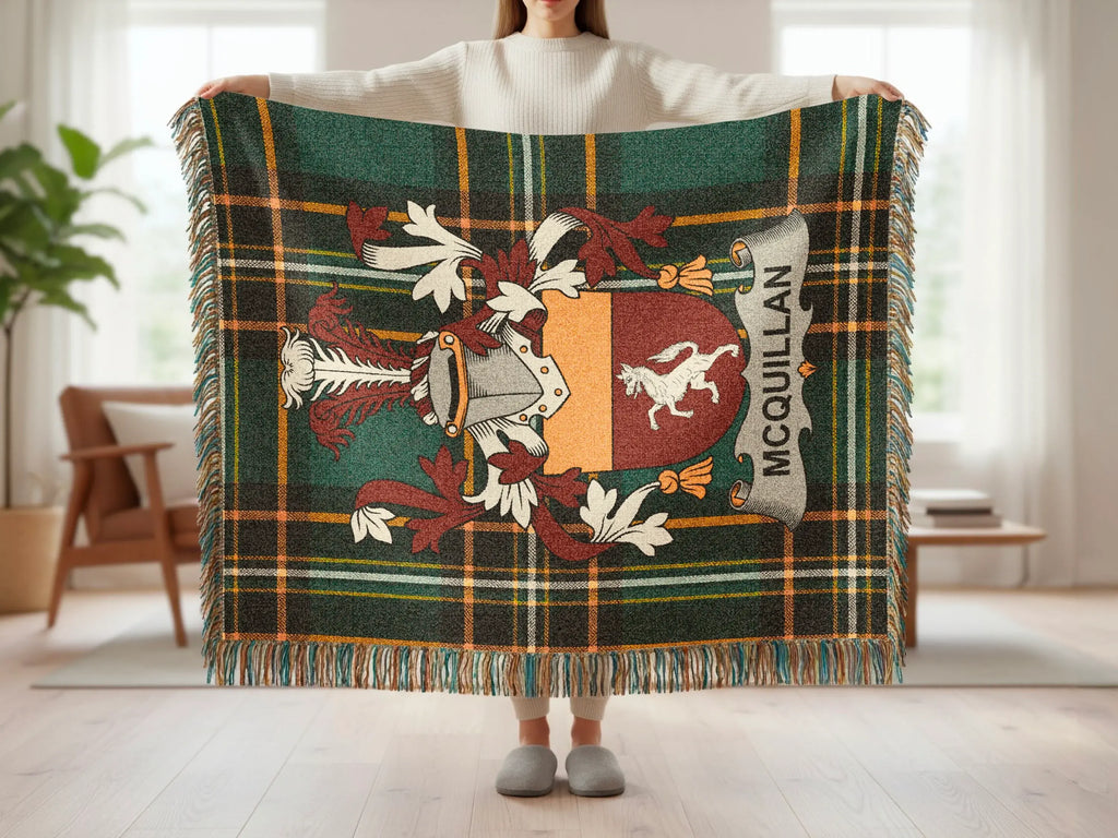 Tartan blanket with McQuillan family crest and fringe.