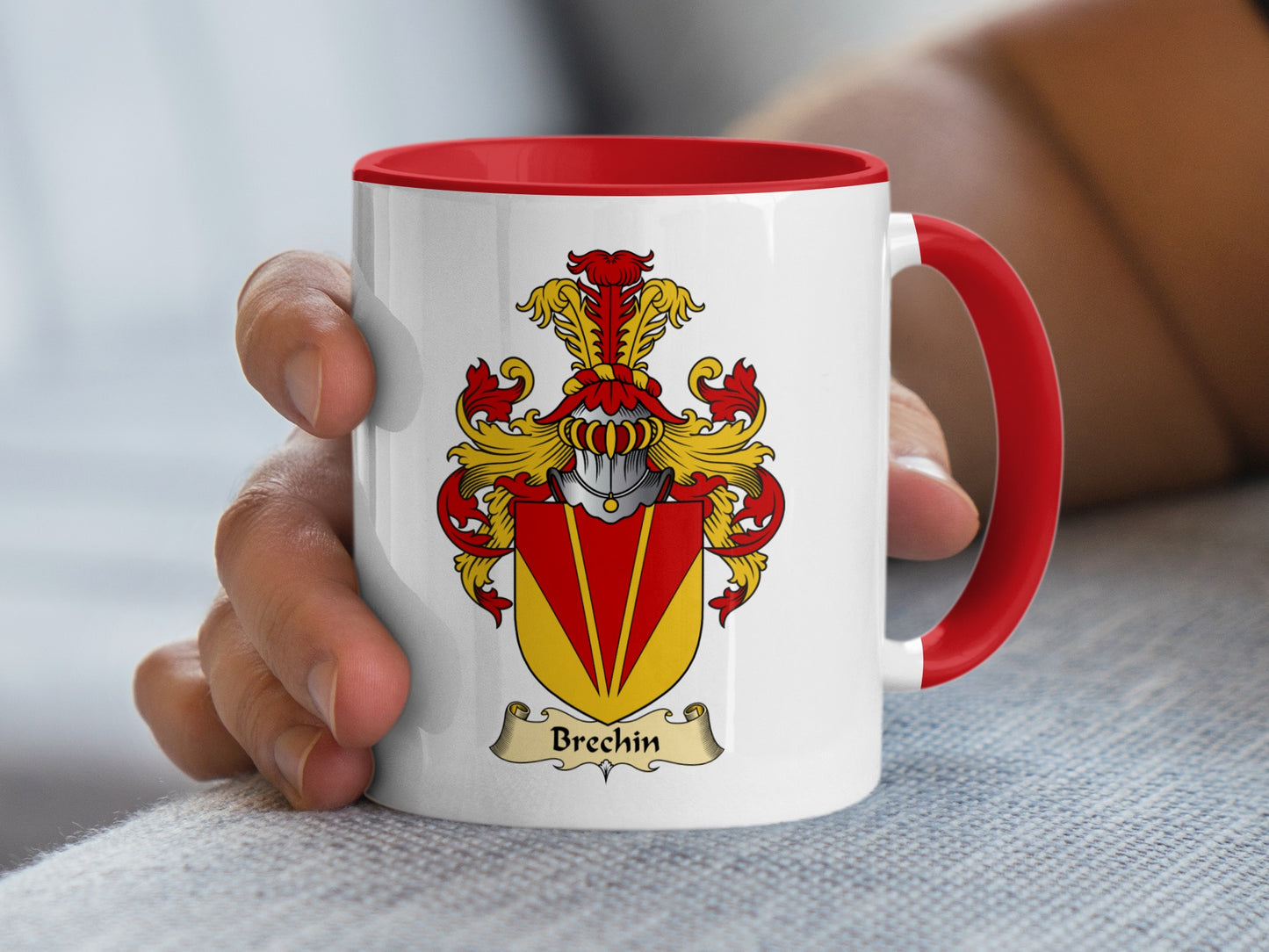 White mug with red handle featuring Brechin family crest on a grey textured surface.