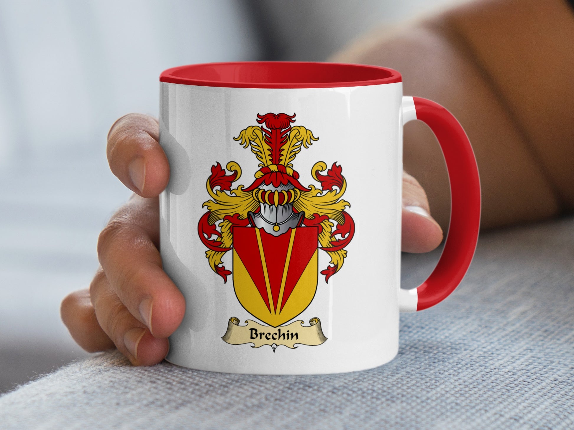 White mug with red handle featuring Brechin family crest on a grey textured surface.