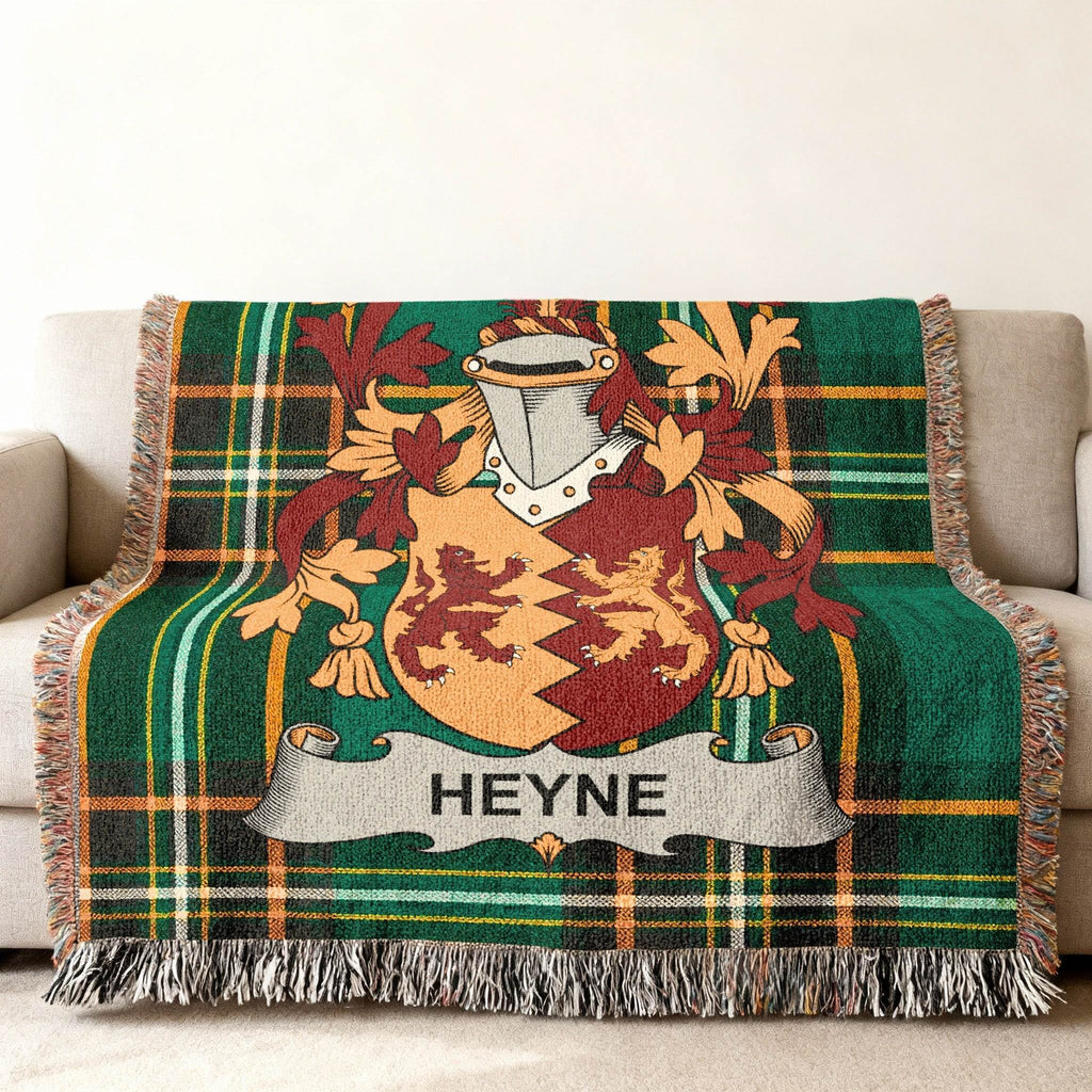 Tapestry throw blanket with green plaid and Heyne family crest.