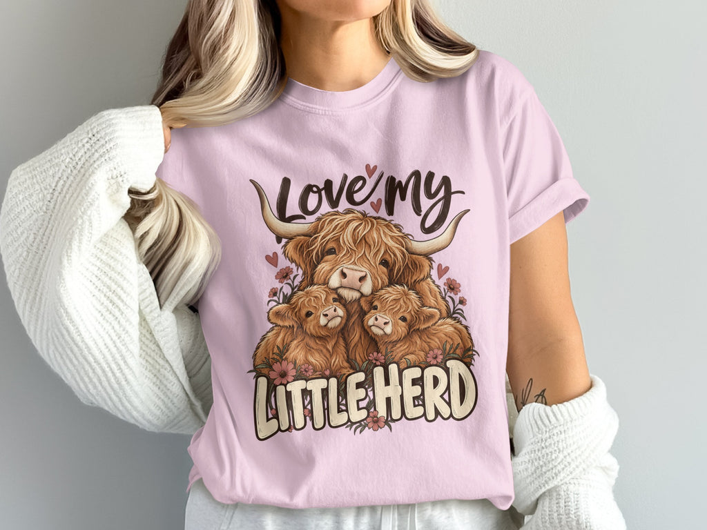 Model wearing the Love My Little Herd Highland cow Comfort Colors T-shirt in Blossom