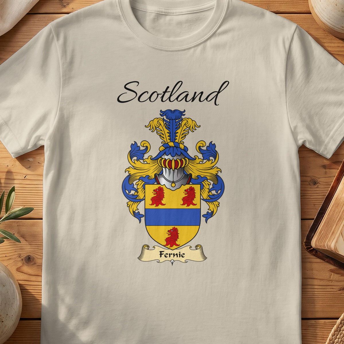 Sand Fernie Scottish family shield T-shirt featuring a blue horizontal band between red motifs on gold