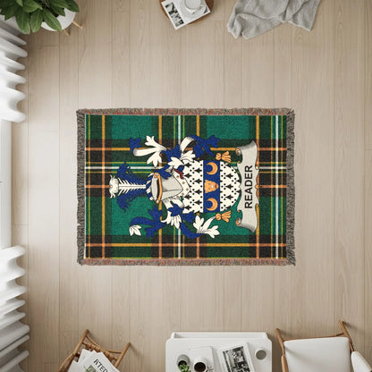 Woven throw blanket with green and blue plaid and a crest with the name "READER".