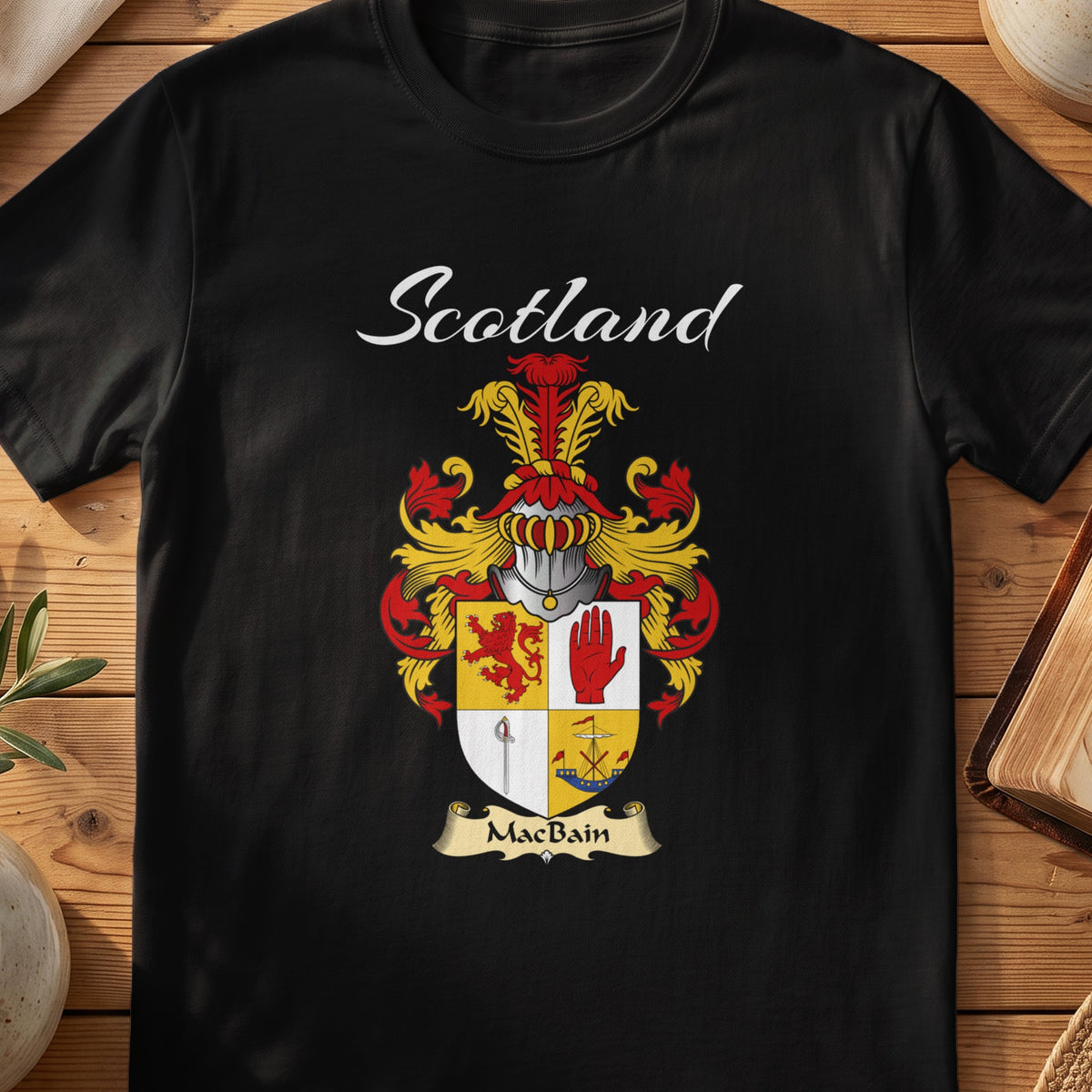 Black MacBain Scottish T-shirt featuring a quartered shield featuring a red lion and an upright hand