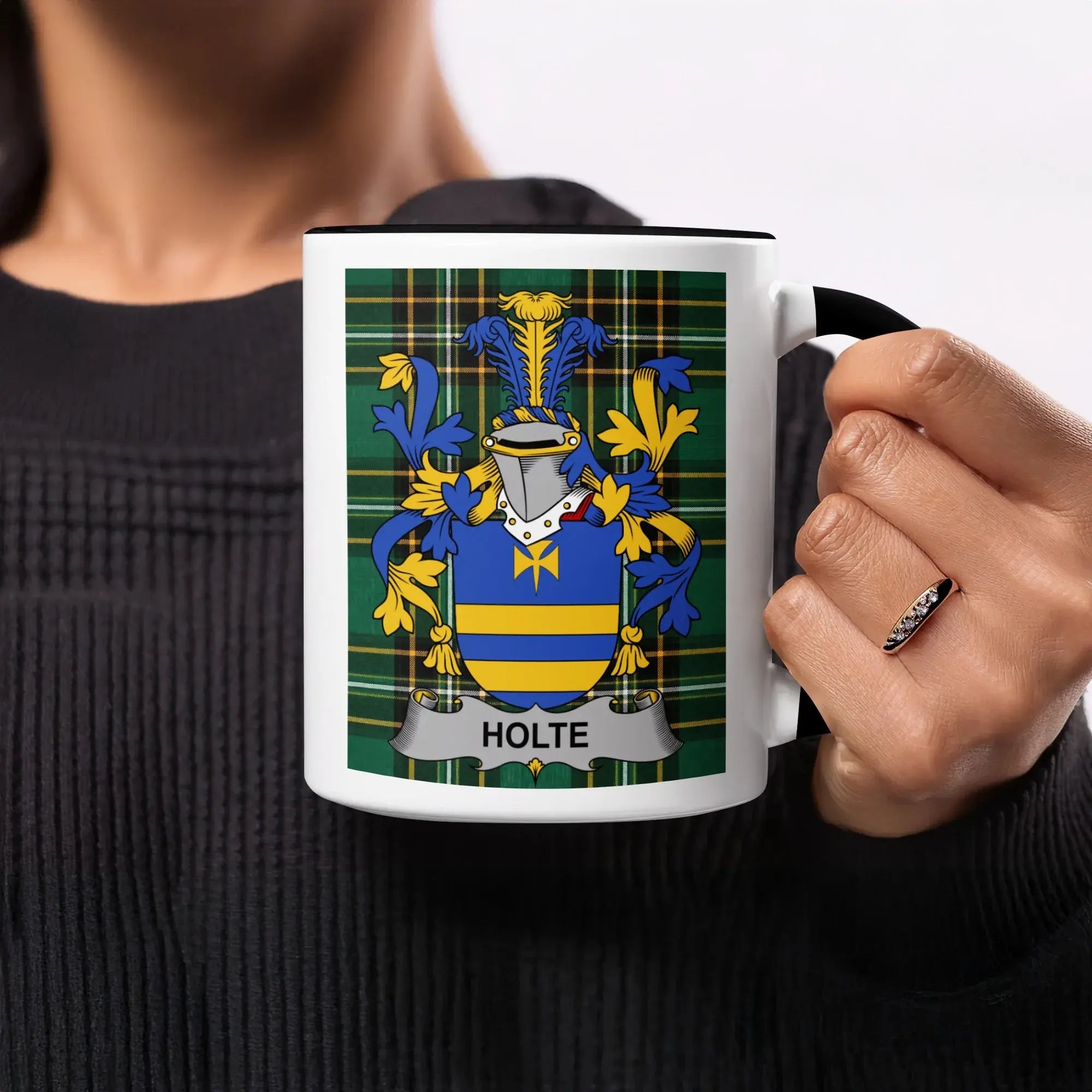 Black mug with Holte family crest on a tartan background.