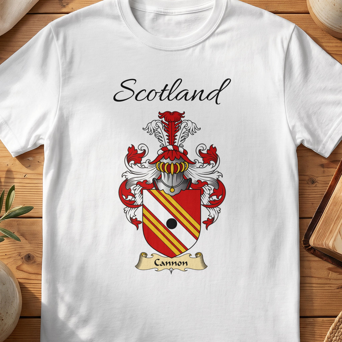 White Cannon Scottish family shield T-shirt featuring red-and-gold diagonal stripes with a black roundel