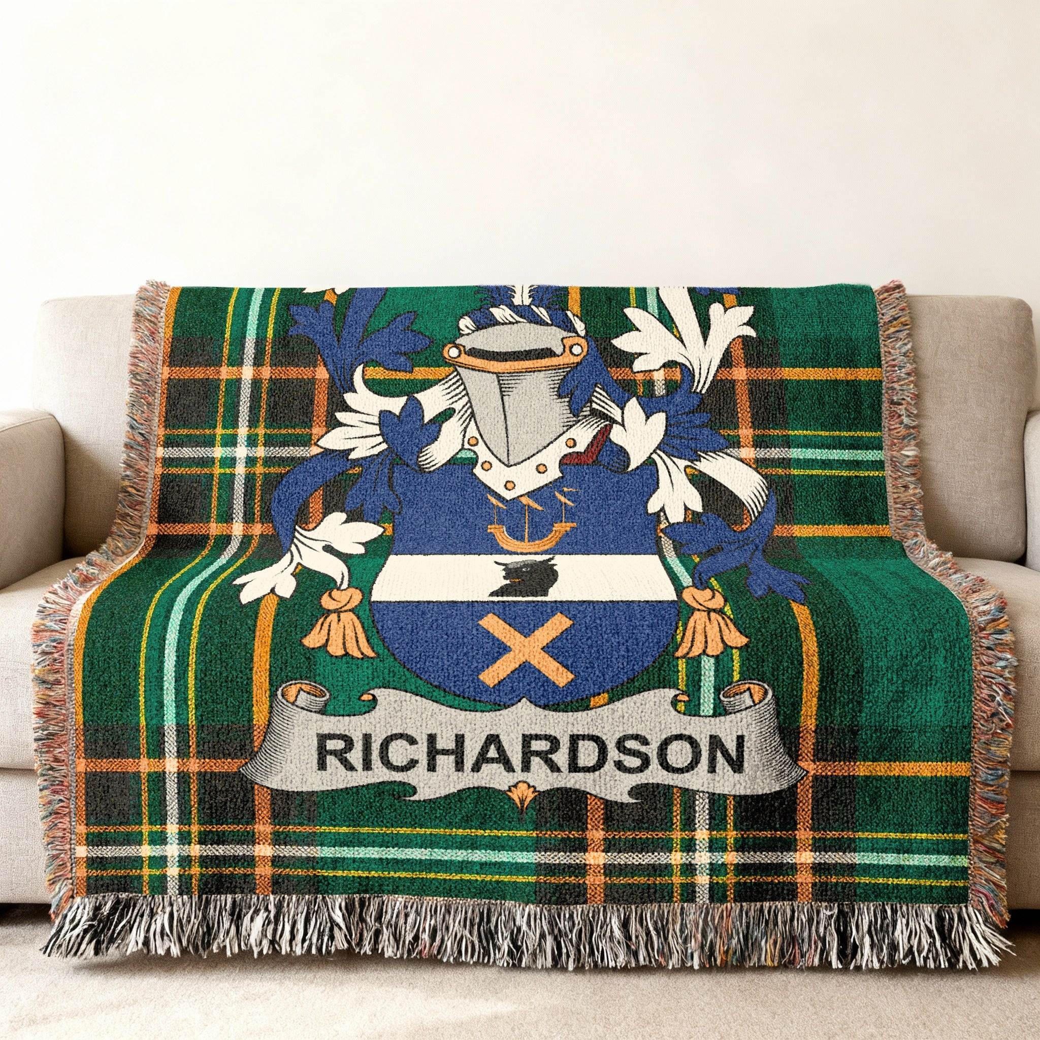 Richardson family crest woven blanket with green tartan pattern on couch.