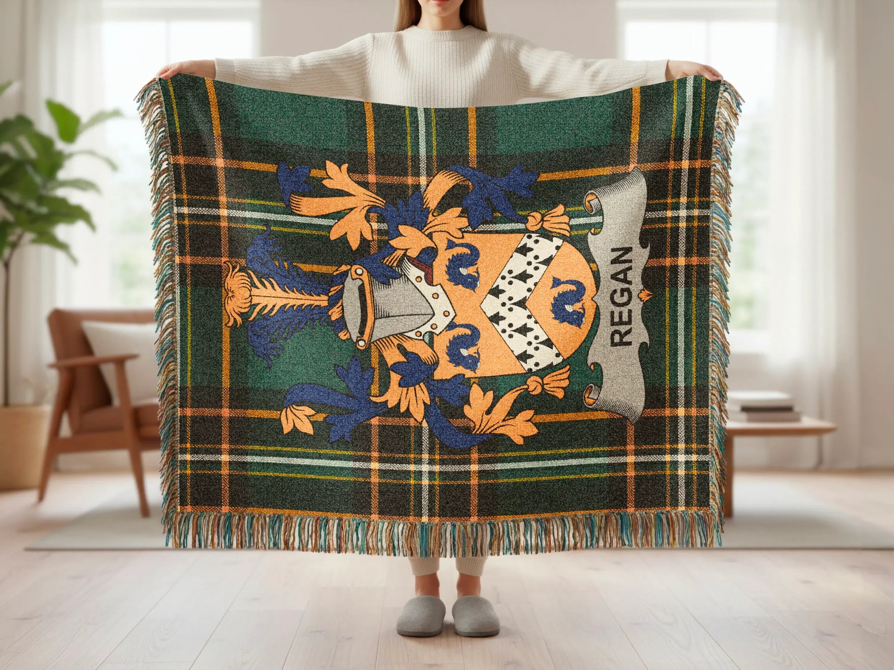 Tartan blanket with the Regán family crest and tasseled edges.