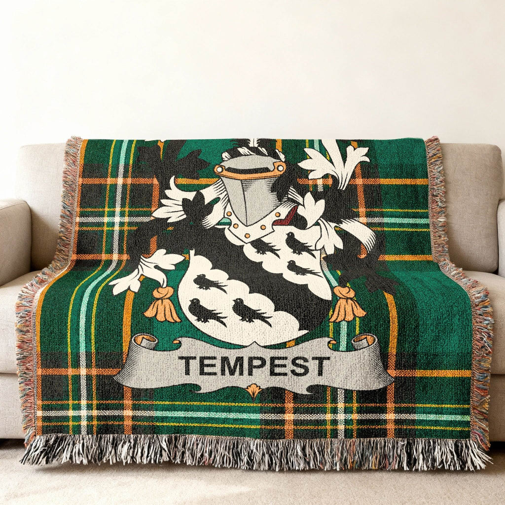 Green tartan throw blanket with white Tempest family crest.